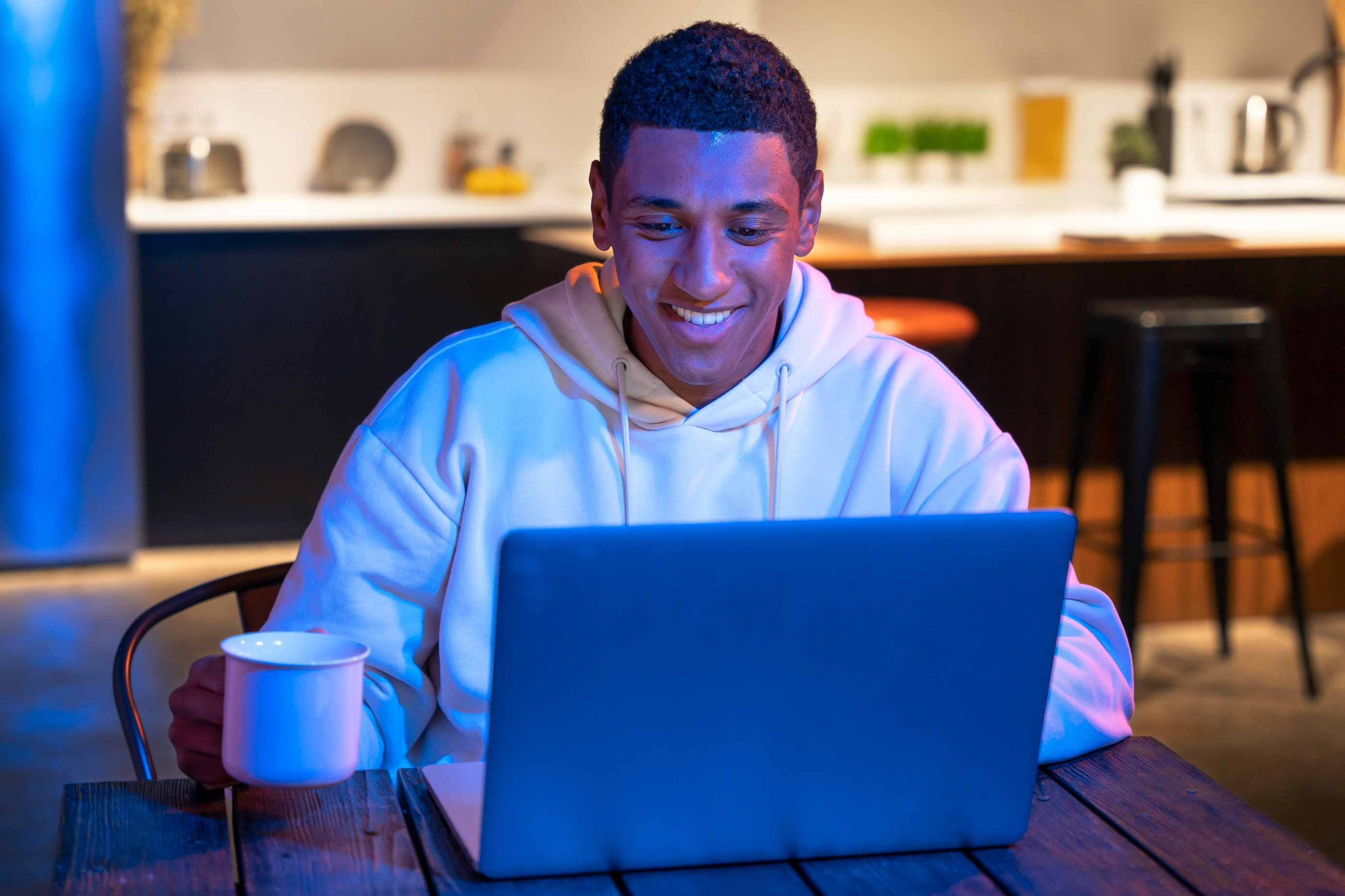 Smiling man using a laptop PC